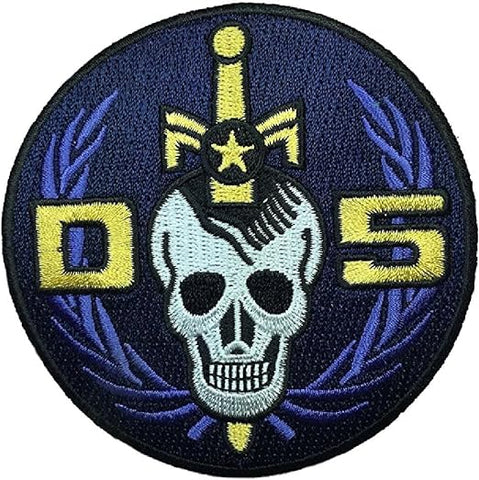 a blue and yellow patch with a skull on it